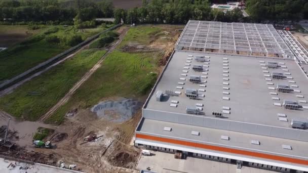 Buildings of logistics center, warehouses in field near the highway, view from height, trucks near the warehouse. — Stock Video