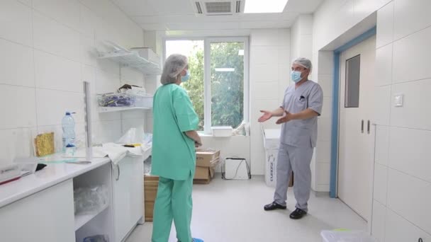 Surgical team scrubbing in before going to operation. Surgeon washing hands before operation. Hospital surgical team preparing for surgery at medical center. Medical professionals at work in scrubs Royalty Free Stock Footage