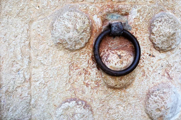 Antique iron handle on a stone door. Israel
