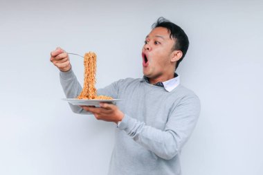 Shock 'un portresi ve Wow Asyalı genç adam eriştenin tadını çıkarıyor. Öğle yemeği konsepti..