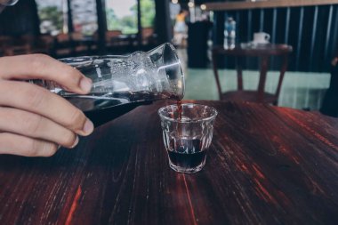 Tahta masadaki eşsiz beher kavanozundan el yapımı v60 sade kahve..