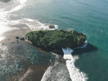 Gündüz vakti Gunung Kidul, Endonezya 'da küçük bir adanın bulunduğu güzel sahil manzarası..