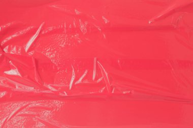 Arkaplan olarak kırmızı plastik sayfa veya kırmızı bant.