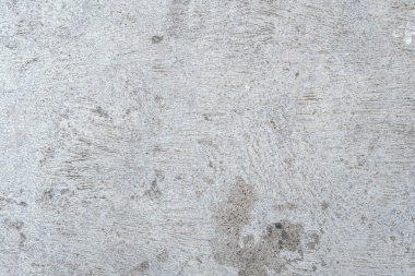 Çatlak ve kırık beton bir yüzeye yakın, desenli bir arka plan..