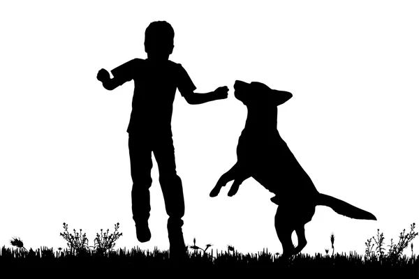 Silueta de un niño con un perro . — Vector de stock