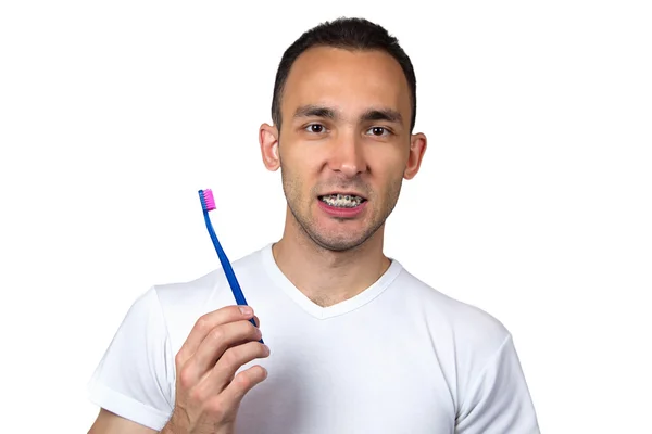 Jeune homme avec supports et brosse à dents — Photo