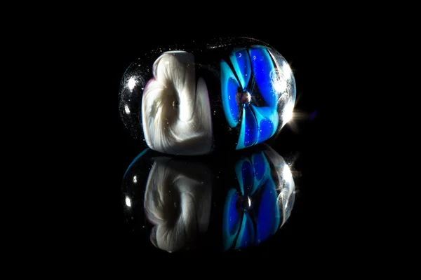 Transparent white and blue glassy bead — Stock Photo, Image