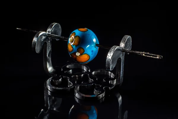 Blue and brown glass bead on stand — Stock Photo, Image