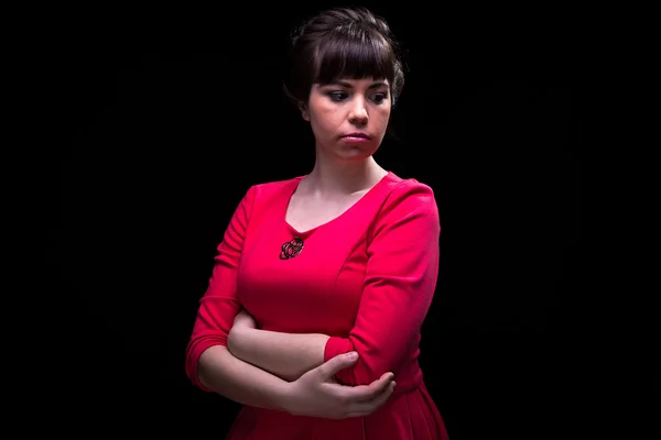 Thoughtful woman in red dress — Stock Photo, Image