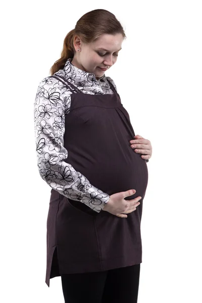 Gravid kvinna tittar på magen — Stockfoto