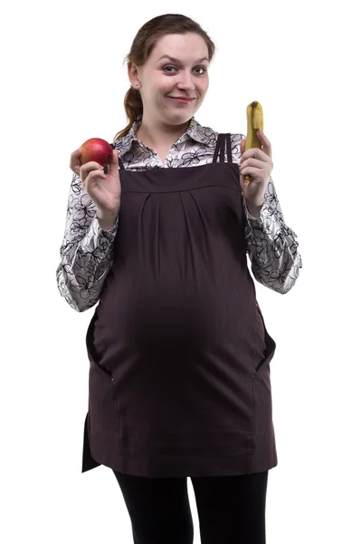 Mujer embarazada mostrando manzana y plátano — Foto de Stock