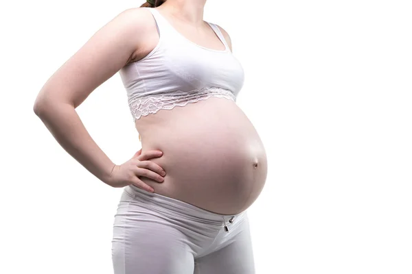 Mulher grávida com as mãos nos quadris, perfil — Fotografia de Stock