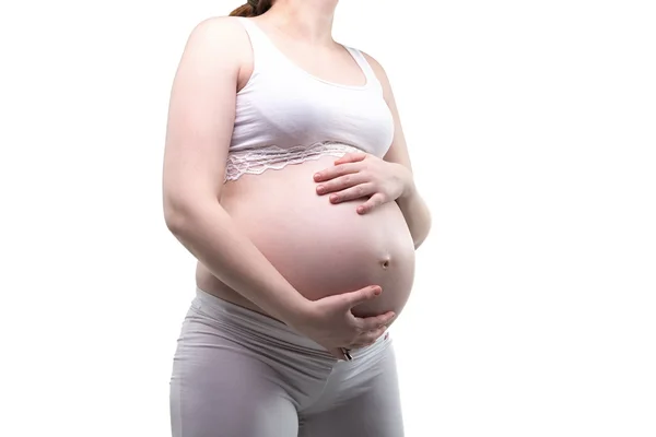 Schwangere junge Frau umarmt Bauch — Stockfoto