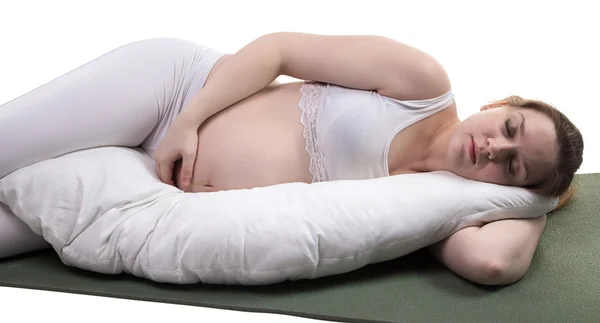 Pregnant lying woman with cushion — Stock Photo, Image