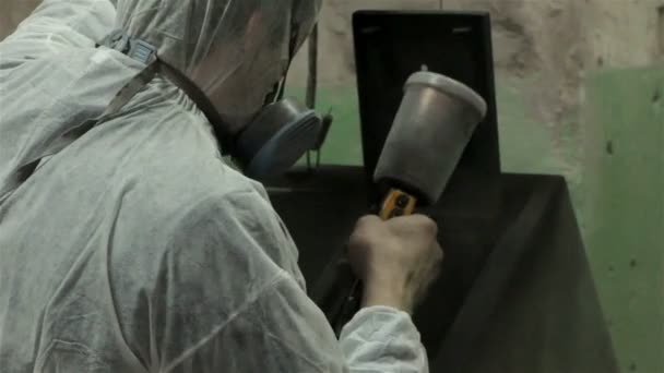 Man in white protect suit painting with powder — Stock Video