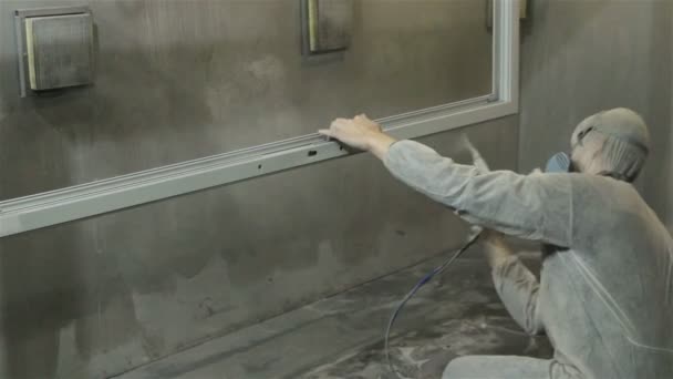 Worker in white suit painting window with powder — Stock Video