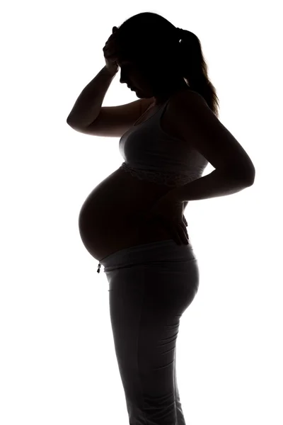 Silhouet van zwangere vrouw met hoofdpijn — Stockfoto