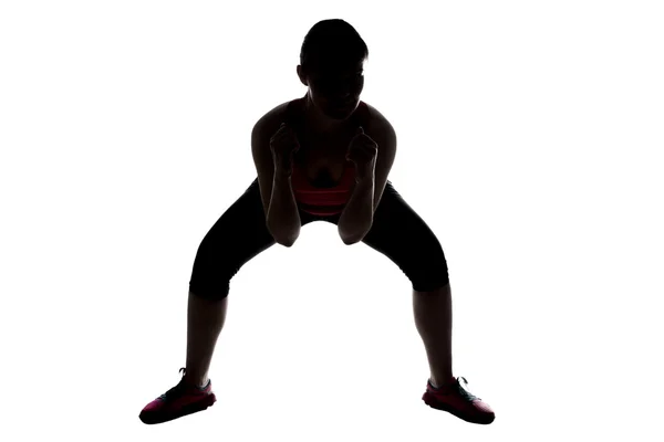 Silhouette of sporty woman, squats sumo — Stock Photo, Image