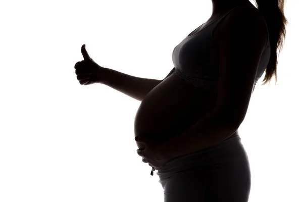 Silhouette de la femme enceinte montrant okey — Photo