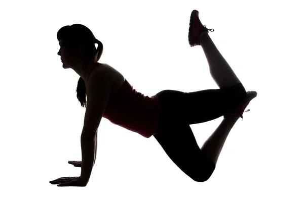 Silhouette of sporty woman in yogas pose — Stock Photo, Image