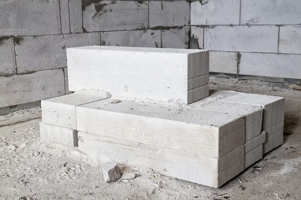 Brick blocks laying on the dirty floor — Stock Photo, Image