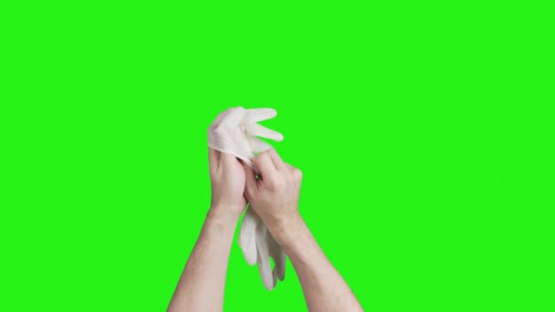 Vídeo de manos masculinas con guantes médicos blancos sobre fondo verde — Vídeos de Stock