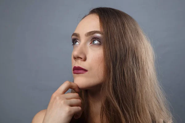 Photo of looking up girl with bright make-up on grey background — Stock Photo, Image