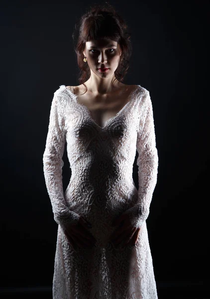 Изображение молодой женщины в прозрачном платье на тёмном фоне — стоковое фото