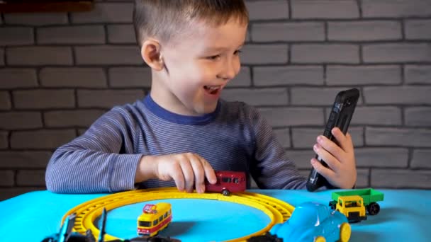 Video call of four year old boy playing with small cars — Stock Video