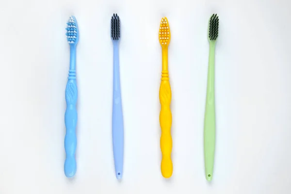 Four colorful toothbrushes on isolated white background — Stock Photo, Image