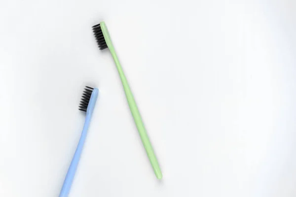 Image of green and blue toothbrushes on isolated white background — Stock Photo, Image