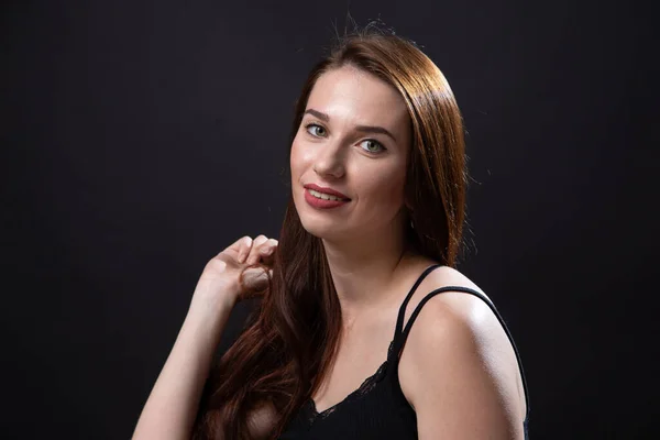 Photo of ginger woman with long hair on dark background — Stock Photo, Image