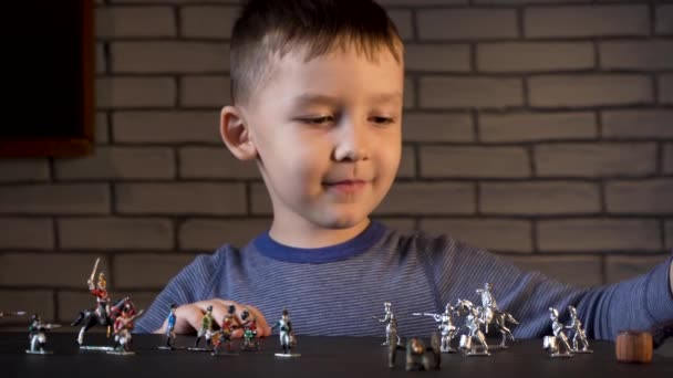 Niño de cuatro años jugando con soldados de hojalata — Vídeo de stock