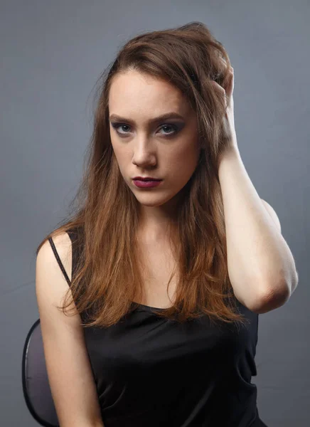 Photo of woman touching her hair with purple lips on grey background — Stock Photo, Image