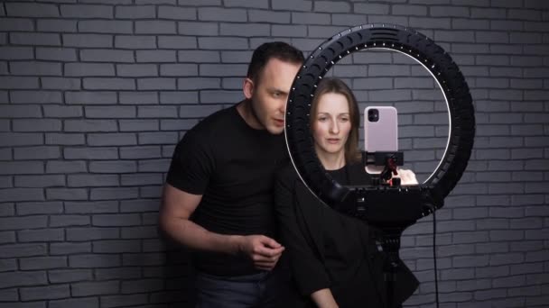 Video of blogger couple with ring led lamp on brick wall background — Stock Video