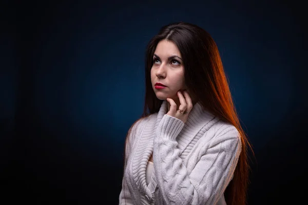 Photo of thinking brunette young woman with long hair and red lips — Stock Photo, Image