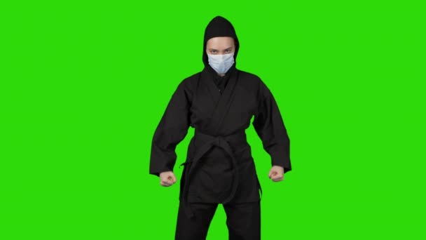 Shooting of woman in black costum ninja on isolated background — Stok Video