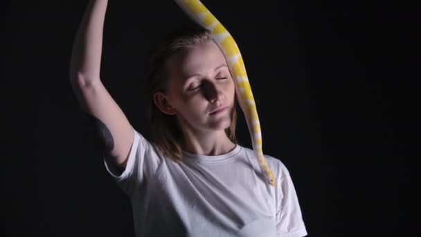 Slow motion shooting of woman with python albino crawling on her head — Stock Video