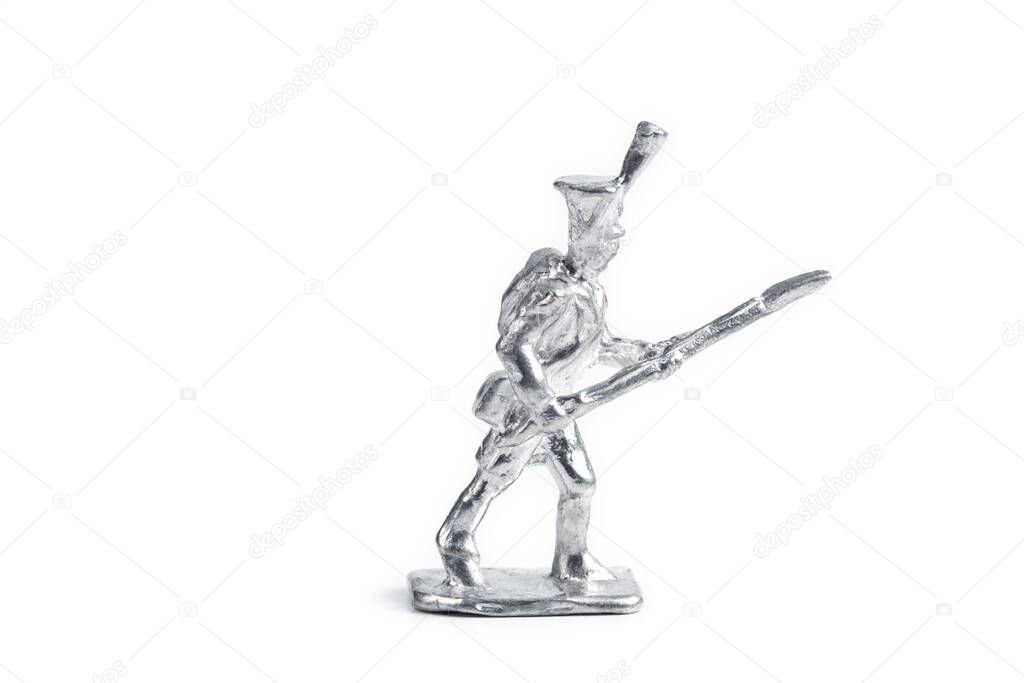 Image of uncolored handmade metal soldier on white background