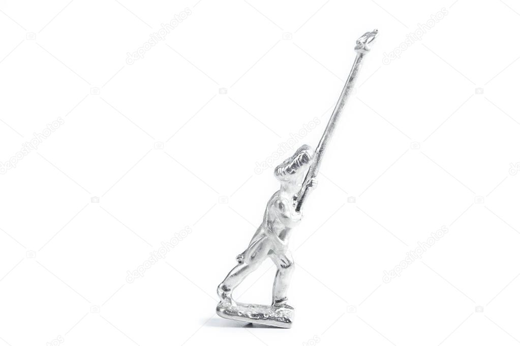 Photo of handmade uncolored tin soldier on the white background