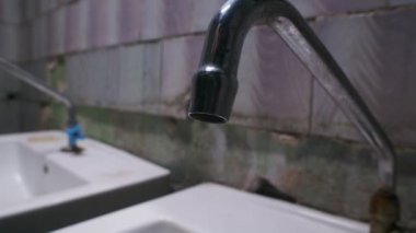 Slow motion video of dripping water from tap