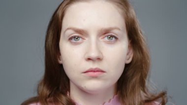 Video of serious woman in pink turtleneck, portrait