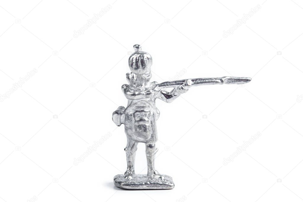 Photo of unpainted handmade metal soldier on white background