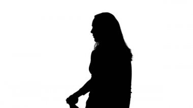 Video of womans silhouette and twirling handgun
