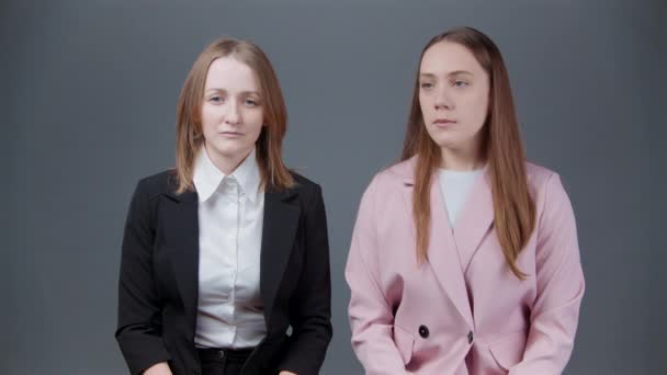 Video de mujeres riendo en chaquetas sobre fondo gris — Vídeo de stock