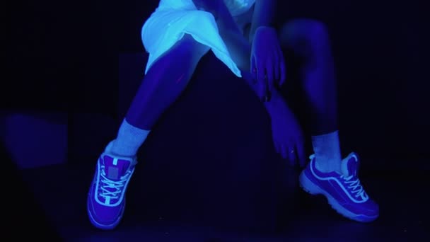 Sitting woman with scary painted face in ultraviolet light — Stock Video