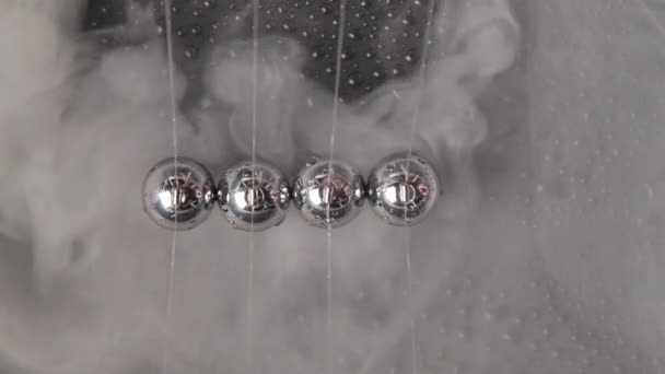 Footage of wet steel newtons balls with smoke, top view — Stok Video