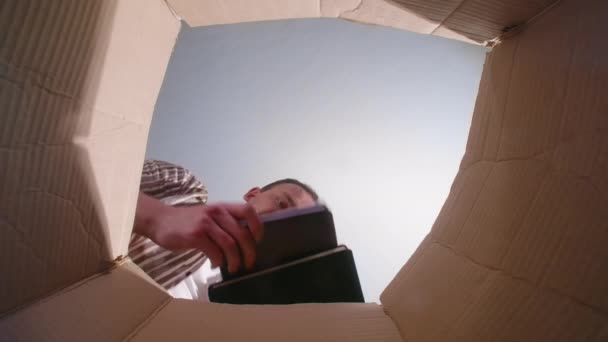 Видео, как человек бросает измятый дневник, вид снизу — стоковое видео