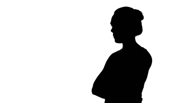 Mädchensilhouette mit verschränkten Armen auf weißem Hintergrund — Stockfoto