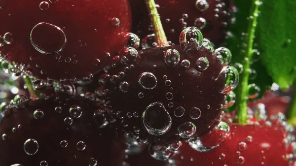 Sweet cherry and soda bubbles, close-up shooting